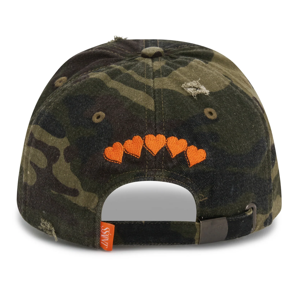 Camouflage baseball cap with heart designs on a white background